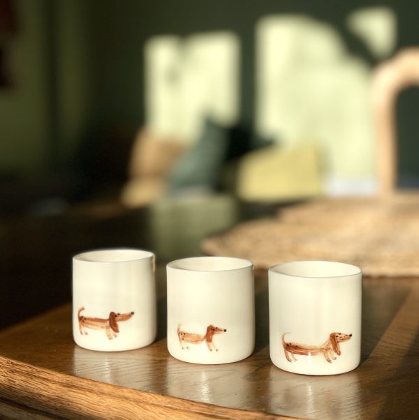 A collection of ceramic dishes with hand-painted dogs